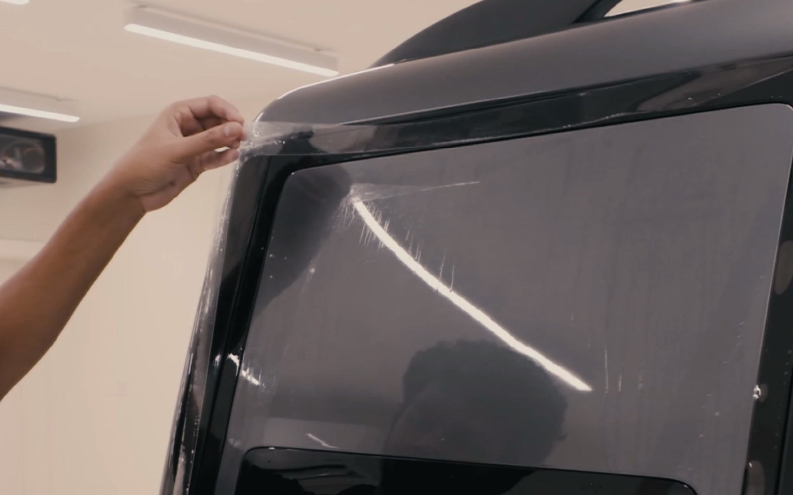 Window film being applied to a rear car window